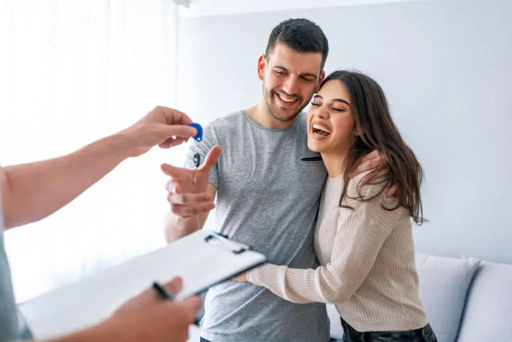 Couple receiving the keys to their new home from their agent