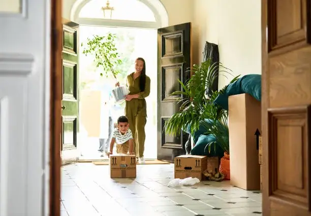 Family smiling in front of their home, representing ITIN home loan financing