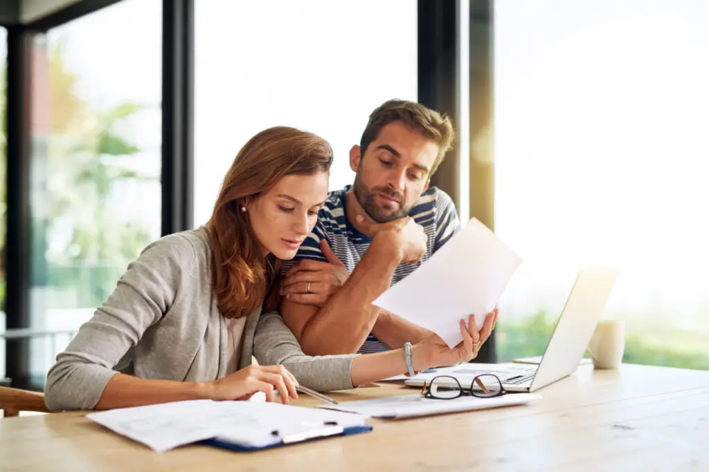 First time buyers reviewing down payment assistance paperwork together at a table