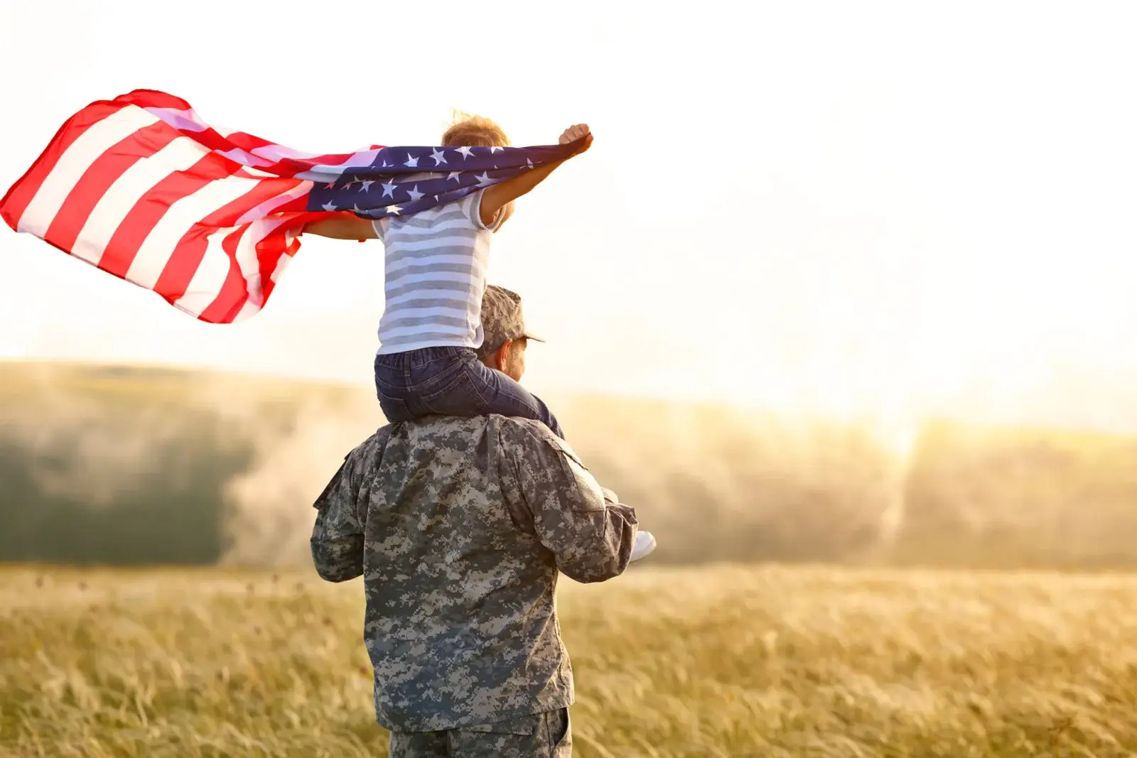 Military family smiling outside their home, representing VA home loan benefits